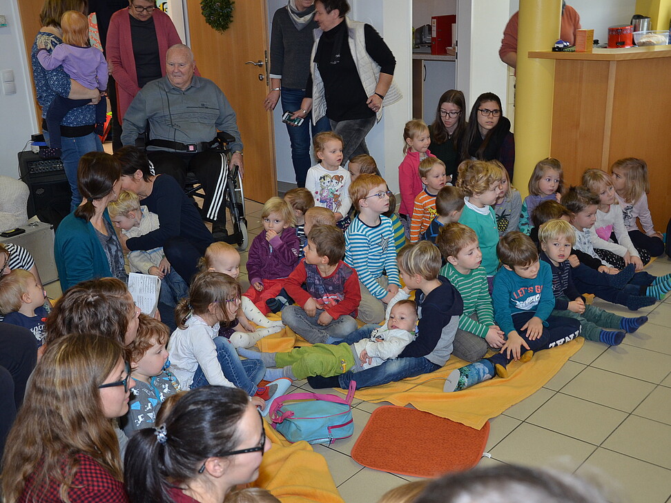 viele Kinder sitzten im Kreis und warten auf die Vorführung